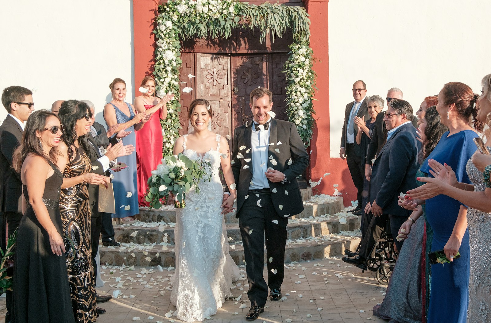 a bride and groom walking down the aisle
